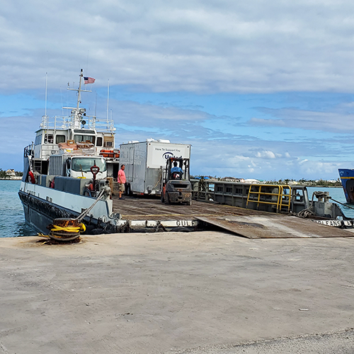 Boat sterned up to the dock for unloading of donations and equipment for disaster recovery and hurricane relief efforts.