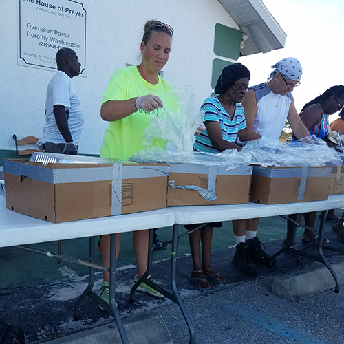 Volunteers serving breakfast at food distribution center.