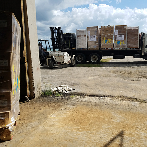 Old truck loaded with pallets of donations and food shipped by GSSM for disaster relief support.