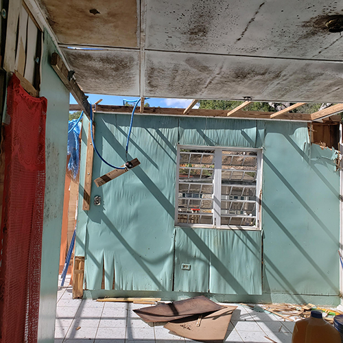 Gutted home with one blue wall left standing that would be rebuilt by volunteers after category 5, hurricane Maria hit Puerto Rico.