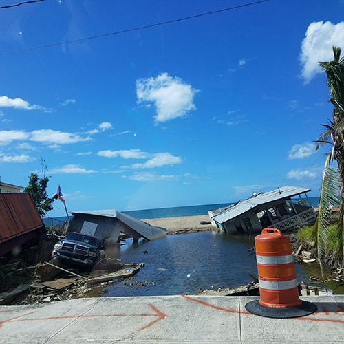 Two homes sunk into the ground in the aftermath of Hurricane Maria.