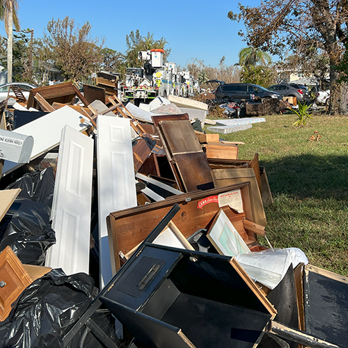 Piles of debris removed from all the homes on a street that flooded during hurricane.