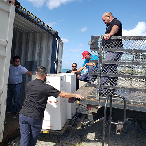 Men from a local municipality load their truck with mattresses donated to Puerto Rico in the aftermath of Hurricane Maria.