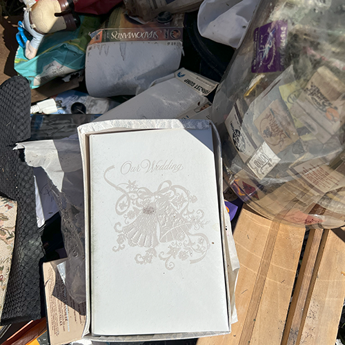 A wedding album sits on top of a pile of debris after a homeowner lost everything due to flooding during a hurricane.